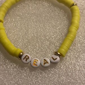 Yellow Beaded Bracelet with 'REAL' Letter Beads
